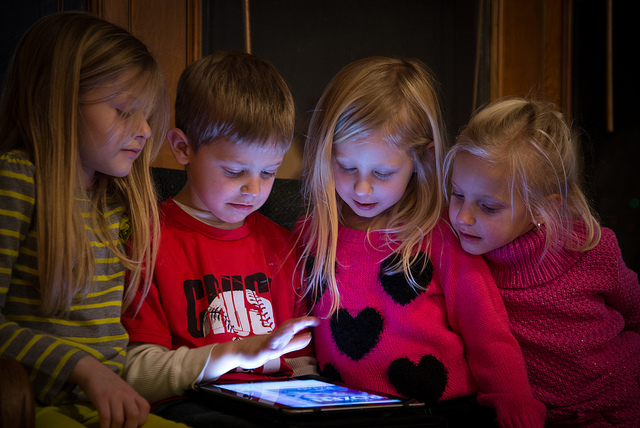 Kinder spielen mit einem Tablet